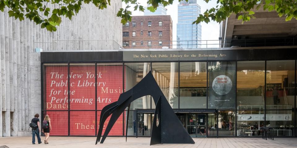 Exterior of the Library for the Performing Arts, including a large black sculpture by Alexander Calder in the foreground. 
