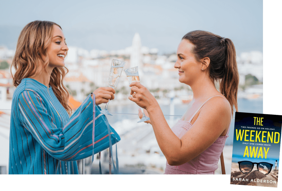 two women raise champaign glasses to each other against a backdrop of a Croatian city 