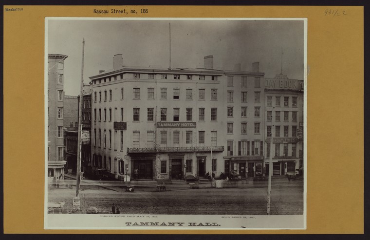 Exterior black and white image of building with sign Tammany Hall over entrance