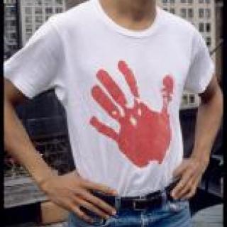 Image of man in shirt with bloody handprint on it.