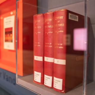 Close up of three red books in a display case at the Library's Made at NYPL exhibition.