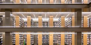 Interior photo of bookshelves filled with books in a brightly lit room