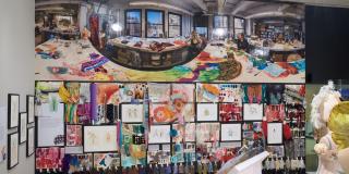A view of the final wall covered in costume sketches and material swatches. A portrait of Willa Kim and Sally Ann Parsons in their studio is at the top. 