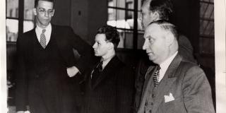 Photograph of Mary Baker (center) with lawyers in court.